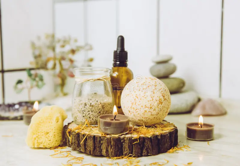 side-view-home-wellness-spa-products-orange-bath-bomb-aroma-bath-salt-sea-sponge-tea-candles-lit-side-view-home-wellness-spa-176384800